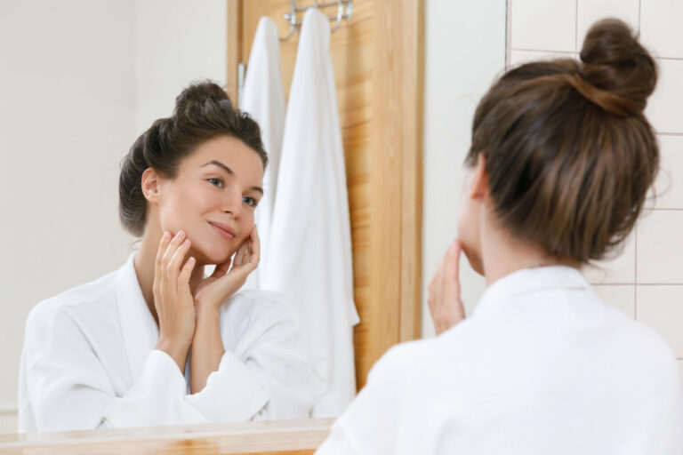 Young,Woman,Is,Looking,Into,The,Mirror,At,Morning